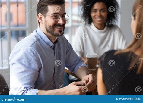 Smiling Multiracial Coworkers Brainstorm At Office Briefing Stock Photo