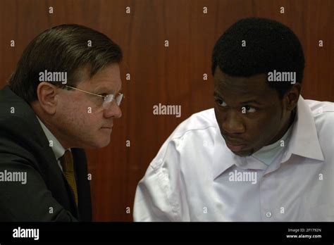 Lionel Tate confers with his attorney H. Dohn Williams (left) before