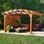 Wooden Arched Pergola With Privacy Wall