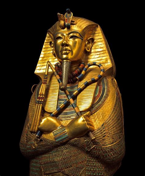 An Egyptian Statue Is Shown Against A Black Background With The Image