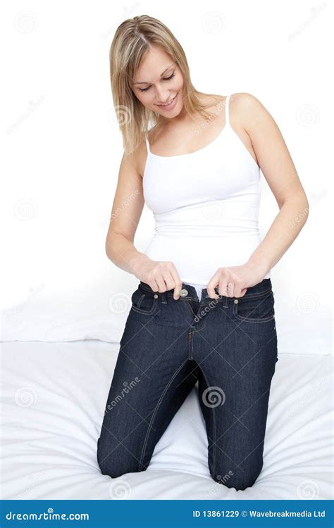 Beautiful Woman Putting On Tight Jeans On A Bed Stock Image Image Of