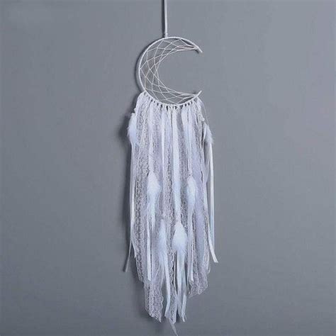 A White Dream Catcher Hanging On The Wall Next To A Gray Wall With A