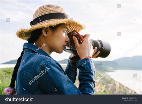 Young Asian Woman Photographer Holding Dslr Stock Photo 1824607124