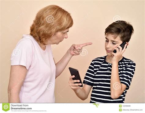 Mother Scolding Her Son With Two Smarthphones Stock Photo Image Of