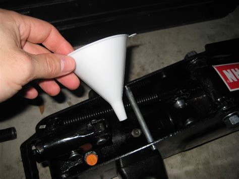 Now you have to add hydraulic oil to the chamber. Craftsman-Floor-Jack-Hydraulic-Oil-Reservoir-Filling-Guide-008