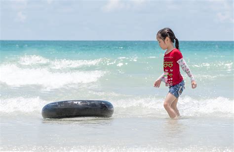 Little Asian Girl Run Play Waves On The Beach With A Ifebuoy Stock