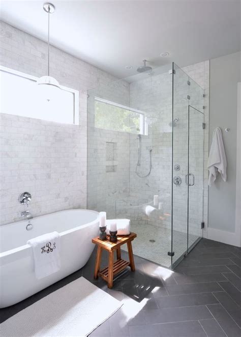 white bathroom  standing tub monogrammed towel grey
