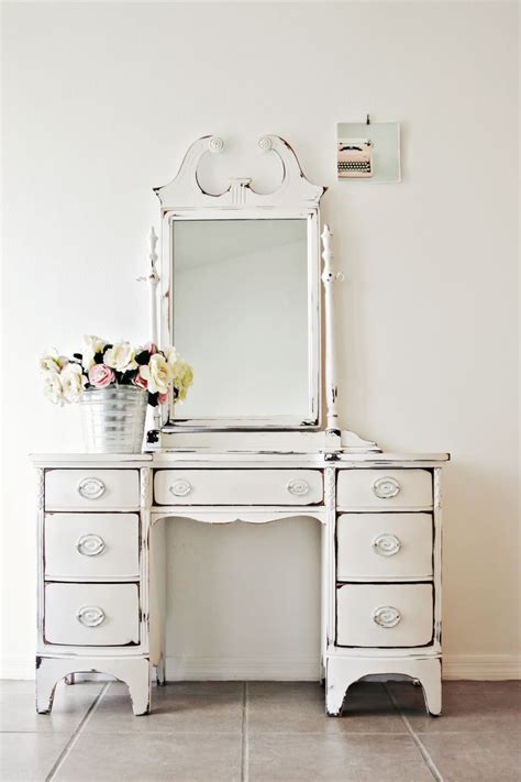 The case features reeded and dental molding details. distressed white vintage vanity | Vintage Interiors ...