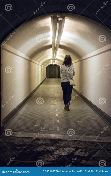 Woman Walking Through An Underground Tunnel Stock Photo Image Of