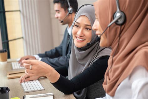 Happy Beautiful Asian Muslim Women Working In Call Center Office Stock