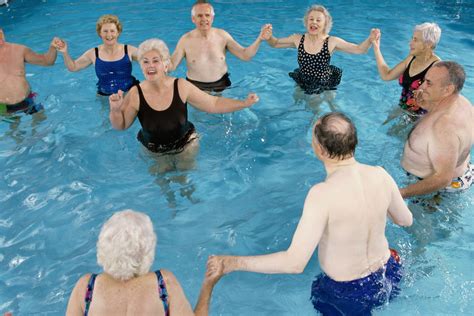 Group Of Senior People Performing Water Aerobics In A Swimming Pool