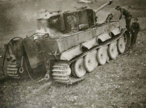 A Burned Out Tiger 1 Gets A Inspection From Several Unknown Individuals