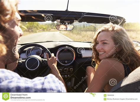 girlfriend a passenger sitting behind female motorcyclist on a motorbike cheerful females
