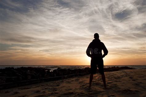 Man Standing Looking At The Sunset In The Beach Royalty Free Stock