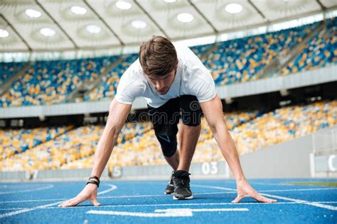 Confident Male Athlete Standing In Starting Position Ready For Running