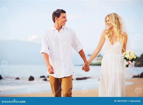 Bride And Groom Romantic Newly Married Couple Holding Hands Walking On