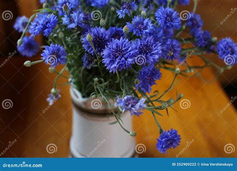 Bouquet Of Wild Blue Cornflowers In A Vase Blurred Floral Background