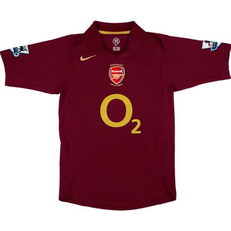 The Shirt Is Maroon With Gold On It And Has An O In The Middle Of The Chest