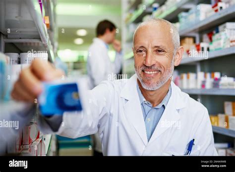 If your health needs it, hes got it. a mature pharmacist doing
