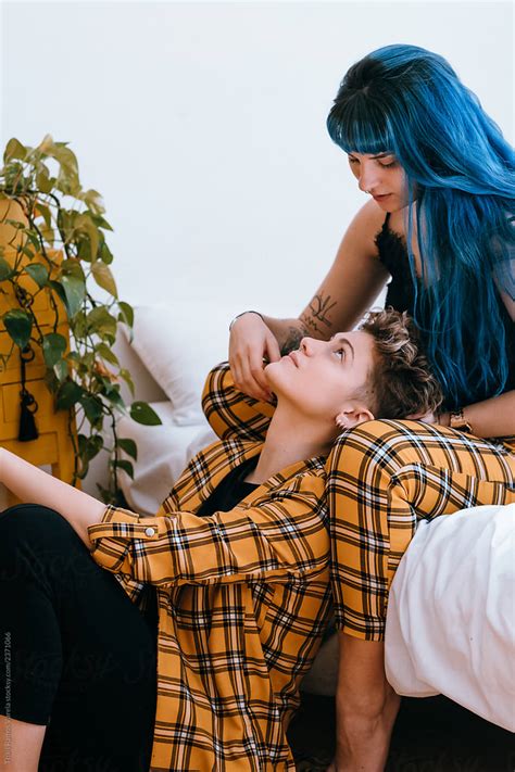 Lesbian Couple Dressed In A Yellow Outfit Are Comfortable In Their Bright White Room By