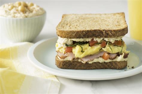 Breakfast Sandwich With Hummus Scrambled Eggs And Tomato