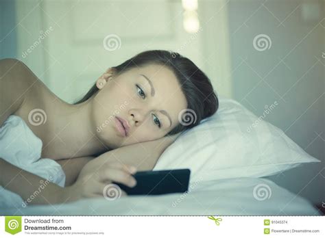 A Beautiful Female Lies In Bed And Can Not Fall Asleep And Reads News