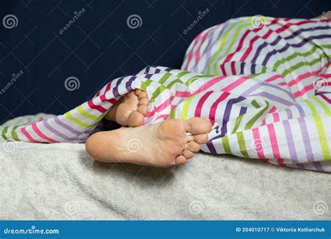 Female Feet Of A Young Girl In The Bedroom In Bed Close Up Stock Image