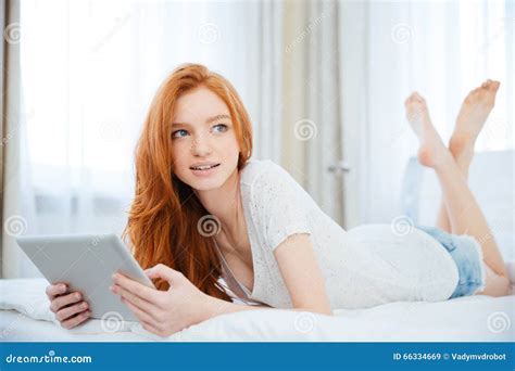Woman Lying On The Bed With Tablet Computer Stock Photo Image