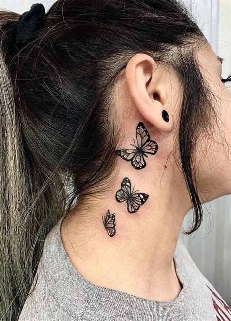 A Woman S Neck With Three Butterflies Tattoo On Her Left Side Behind The Ear