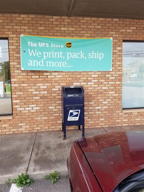 This USPS box directly centered below a UPS store sign. : r