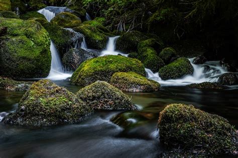 Premium Photo Closeup Shot Of A Waterfall Surrounded By Mossy Rocks