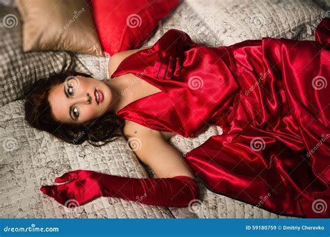 Sensual Brunette In A Red Dress Lying On The Bed Stock Image Image Of Female Adult