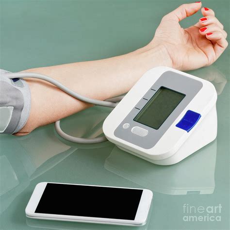 Measuring Blood Pressure At Home Photograph By Microgen Imagesscience