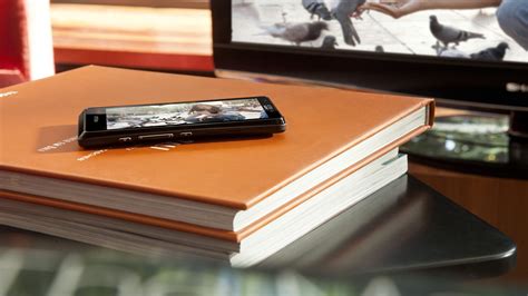 Black Android Smartphone On Orange Book Hd Wallpaper Wallpaper Flare