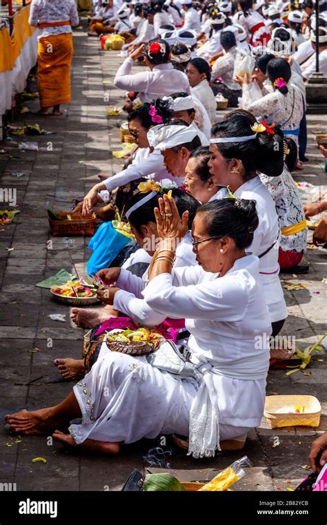 Balinese Hindu People Praying During The Batara Turun Kabeh Ceremony