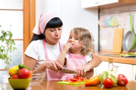 Mother And Daughter Cooking On Kitchen Stock Photo Image Of