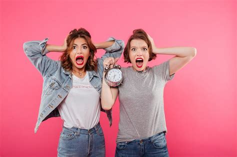 Shocked Women Friends Holding Alarm Stock Image Image Of Brunette