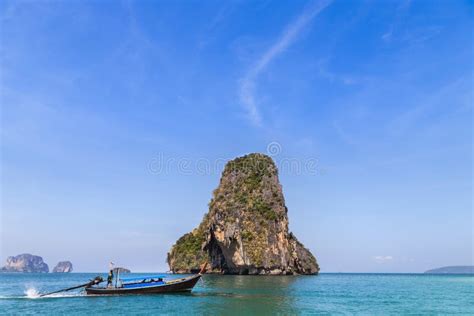 Tropical Sea With Limestone Rock And Longtail Boat At Railay Beach