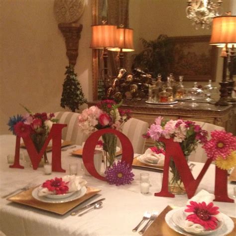 The Table Is Decorated With Flowers And Letters That Spell Outmomon It