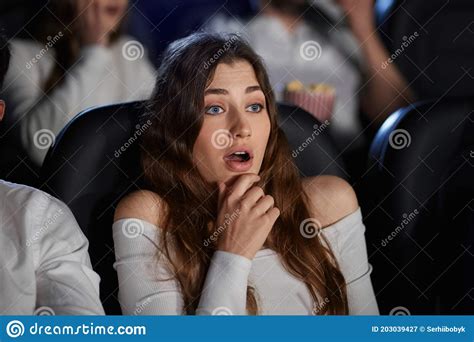 caucasian girl watching horror movie in movie theater stock image image of people film