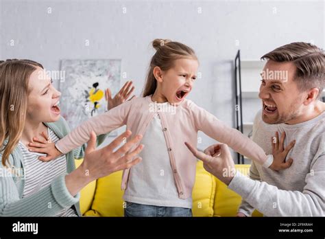 Yelling Child Pushing Away Quarreling Parents Stock Photo Alamy