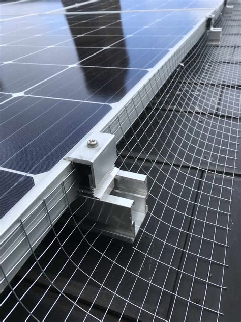 Close off the space above the rafters where pigeons roost and nest with industrial bird netting. How do you stop pigeons from going under your solar panels?