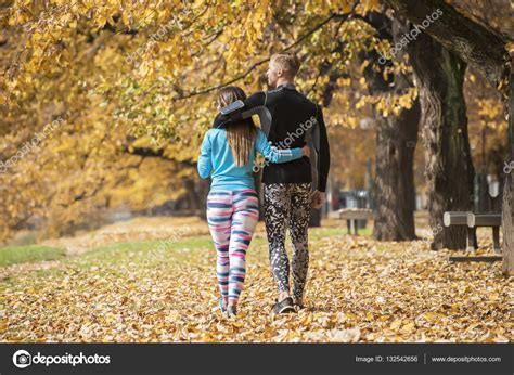 Beautiful Young Couple Walking Together In The Park Back View Autumn