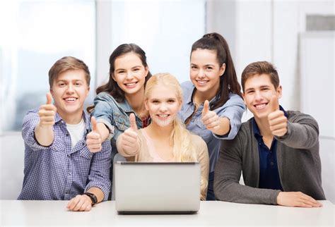 Smiling Students With Laptop Showing Thumbs Up Stock Photo Image Of