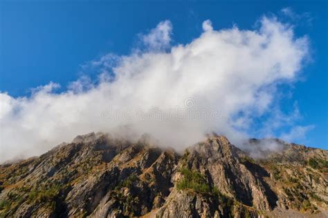 Large White Cloud Like A Cap Descended On A Mountain Peak High