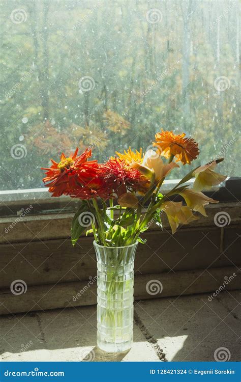 Bouquet Of Flowers In A Glass Vase On The Windowsill On The Background