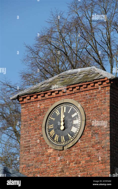 A Large Outdoor Clock On A Brick Building Tower Stock Photo Alamy