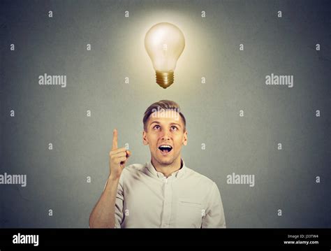 Young Business Man With Idea Solution And Light Bulb Over His Head