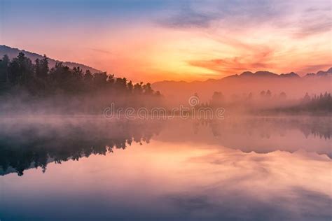 Beauty Sunrise Sky Over Frozen Water Lake Between Hills Stock Image