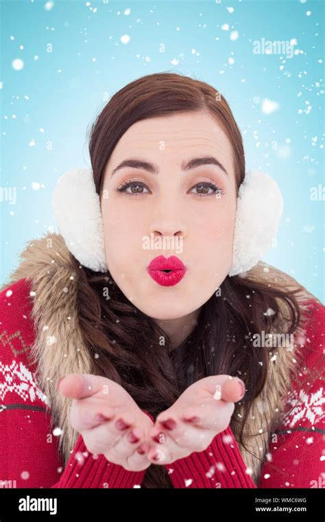 Festive Brunette With Lipstick Blowing A Kiss Against Blue Background